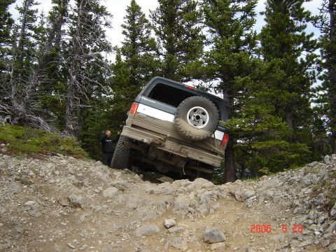 1995 Ford Bronco - This 1995 Ford Bronco navigates a challenging rocky incline during an off-road excursion.