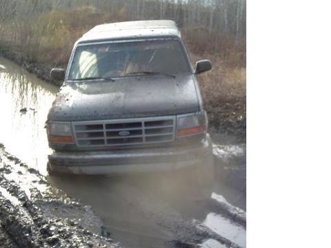 1995 Ford Bronco - This 1995 Ford Bronco is stuck deep in mud on an off-road trail.