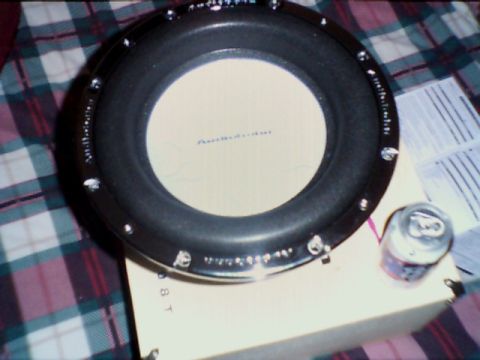 1998 Ford Taurus - A car subwoofer is shown with a soda can and some papers in the background.