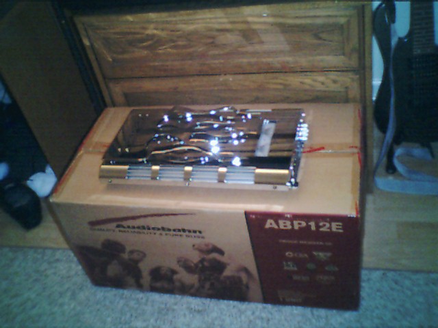 Chrome car amplifier on a box labeled 'Audiobahn ABP12E'