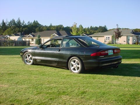 1994 Ford Probe - A dark 1994 Ford Probe GT is shown from a three-quarter front view on a sunny day.