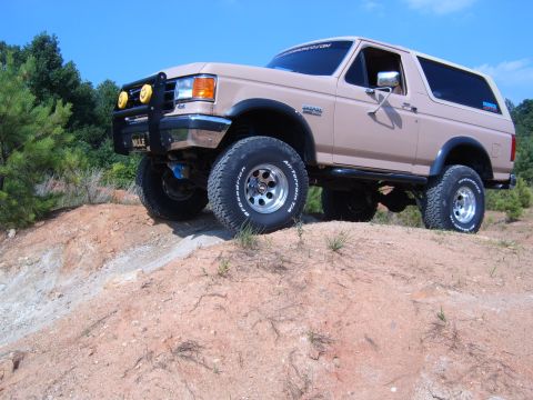 1993 Ford Bronco - This 1993 Ford Bronco is positioned on a dirt incline under a clear blue sky.