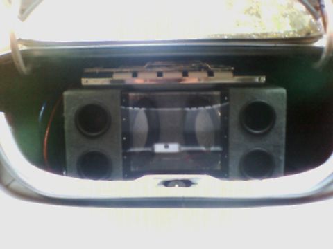 1998 Ford Taurus - A car stereo system is installed in the trunk of a vehicle.