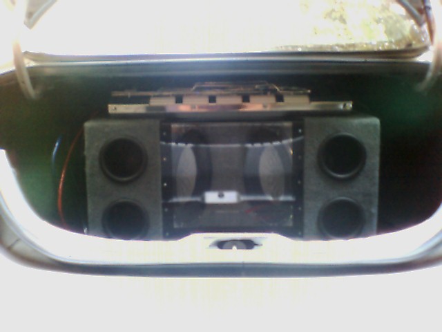 car stereo system with multiple speakers and a clear cover showing internal components
