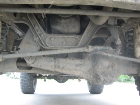 1995 Ford Bronco - The underside of a 1995 Ford Bronco reveals its robust suspension and drivetrain, ready for off-road adventures.