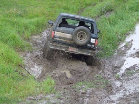 1988 Ford Bronco - Ford Bronco tackling a difficult muddy off-road path.