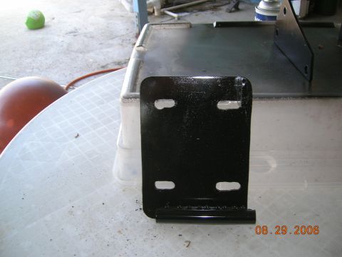 1985 Ford Bronco - A black metal bracket with four mounting holes is shown on a table, with a date stamp of 08.29.2006.
