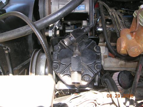 1985 Ford Bronco - Close-up of an engine compartment showing an AC compressor and associated plumbing, dated August 29, 2006.