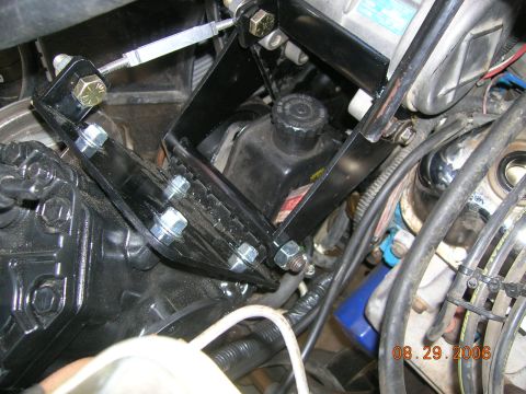 1985 Ford Bronco - Close-up view of engine bay components, including custom brackets and a power steering reservoir, with a date stamp of 08.29.2006.