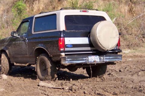 1996 Ford Bronco - Muddy 1996 Ford Bronco rear view, spare tire mounted on the tailgate.
