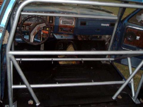1984 Ford Bronco - Interior view of a blue vehicle, likely from the early 1980s, fitted with a roll cage.