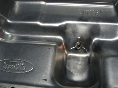 1996 Ford Bronco - This is a close-up view of a Ford oil pan, likely for a Mustang, showing the brand's logo and some embossed lettering.