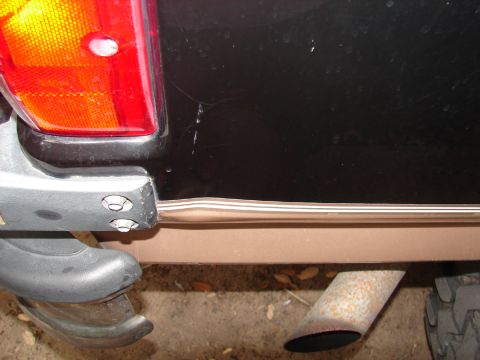 1996 Ford Bronco - Close-up of the rear bumper and taillight assembly on a 1996 Ford Bronco.