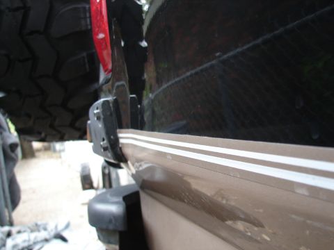 1996 Ford Bronco - Close-up of the rear quarter panel and spare tire mount on a 1996 Ford Bronco.