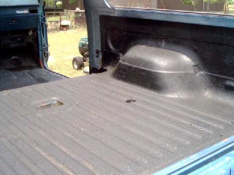 1984 Ford Bronco - The interior of a truck bed, coated with Herculiner, is shown with visible text from Supermotors.net.