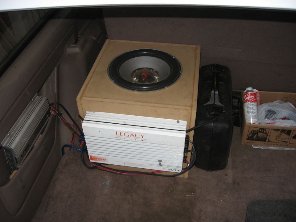 Custom subwoofer box with Legacy 800W amp in a tan cargo area of a Bronco