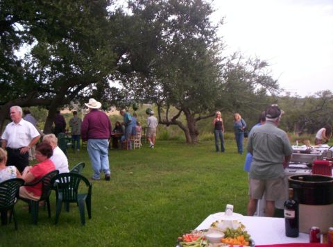 1986 Ford Bronco - An outdoor party is in full swing with guests mingling and enjoying food and drinks.