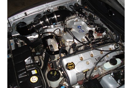 1998 Ford Taurus - Engine bay details show a V8 32-valve engine with aftermarket modifications.
