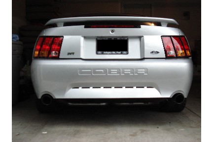 1998 Ford Taurus - Rear view of a silver 2001 Ford Mustang Cobra, SVT badging and distinctive taillights.