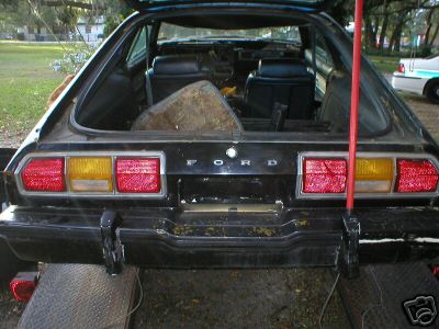 1978 Ford Mustang II - Rear view of a 1978 Ford Mustang II with the trunk open, revealing the interior.
