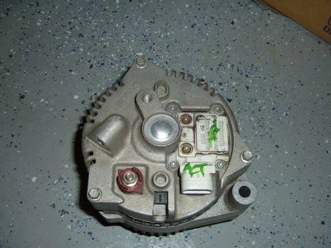 1993 Ford Bronco - This is a close-up view of a vehicle alternator, showing its internal components and some handwritten markings.