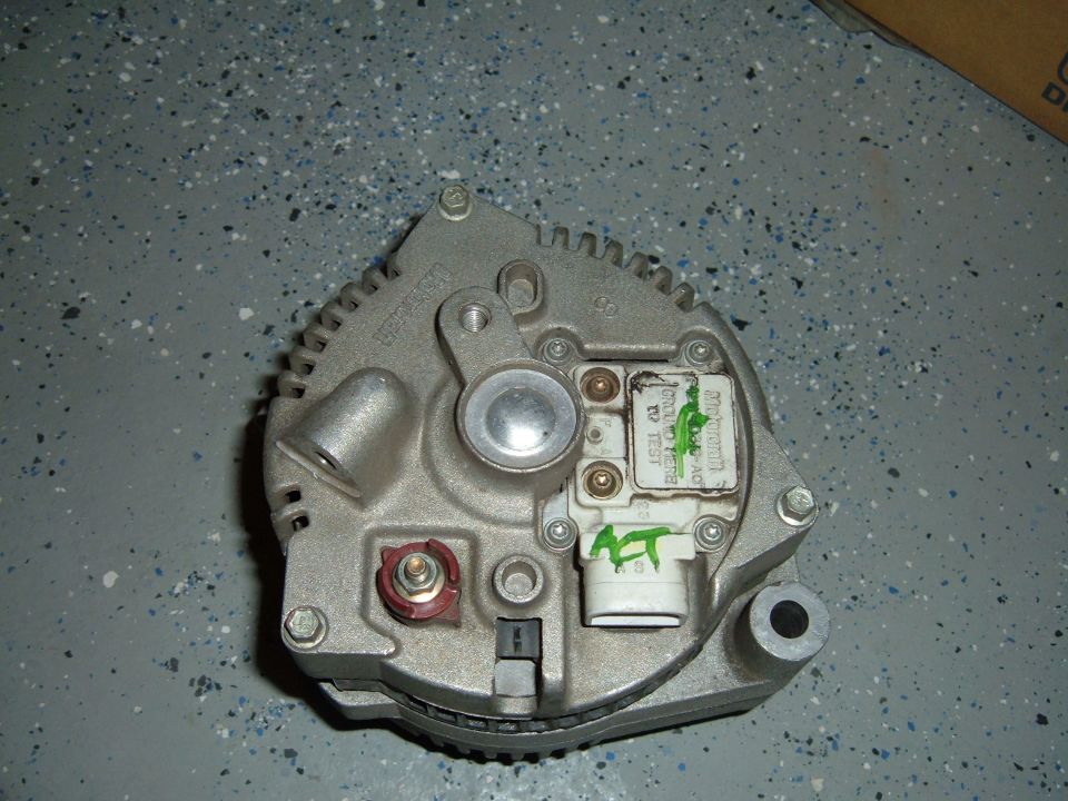 close-up of an alternator with some green markings and text on it