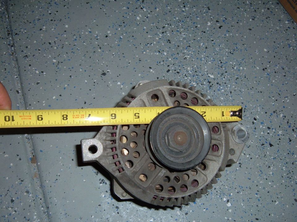 Alternator with tape measure showing approximately 7 inches