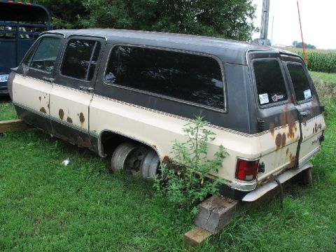 1995 Ford Bronco - This two-tone SUV shows significant rust damage and appears to be in disrepair.