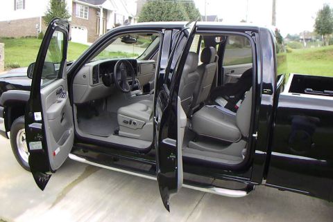 1995 Ford Bronco - Interior view of a black crew cab pickup truck, showing the front and rear seats with all doors open.