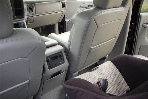 1995 Ford Bronco - The interior of a vehicle is visible, with a focus on the rear seating area and center console.
