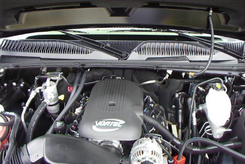 1995 Ford Bronco - Engine bay view showing the Vortec engine cover and various hoses and components.