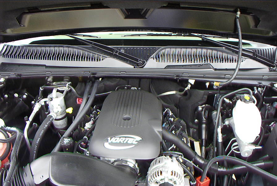 Engine bay with Vortec engine cover visible. Supermotors.net logo in lower right