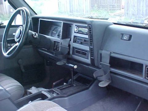 1968 Ford Mustang - The interior of a Jeep Cherokee, its dashboard, steering wheel, and center console.