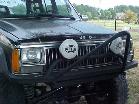 1968 Ford Mustang - The front of a dark-colored Jeep Cherokee is visible, equipped with auxiliary lights and a brush guard.
