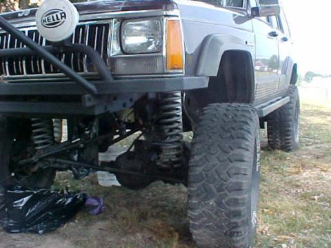 1968 Ford Mustang - This lifted Jeep Cherokee XJ features prominent off-road modifications, including oversized tires and auxiliary lighting.