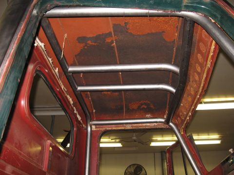 1977 Ford F-150 - Custom roll cage installed inside the cab of a 1977 Ford F-150, showing the interior structure and aged headliner.
