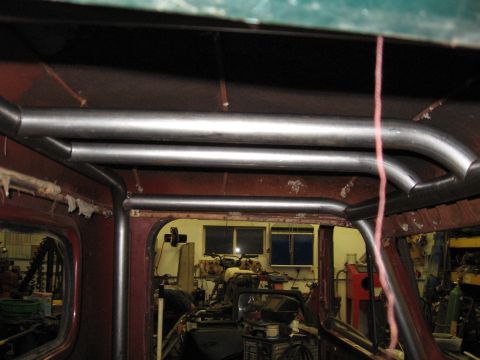 1977 Ford F-150 - Roll cage tubing installation in progress inside a vehicle cab.