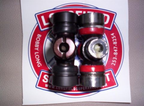 1995 Ford Bronco - Close-up of two universal joints, one black and one silver, resting on a branded sticker.