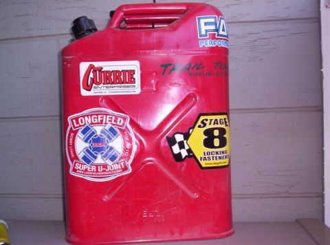 1995 Ford Bronco - A red jerry can is covered in various automotive-themed stickers, including one for Super U-Joints.