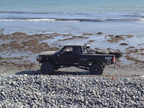 1985 Ford Ranger - Modified 1985 Ford Ranger Baja truck parked on a rocky beach with the ocean in the background.