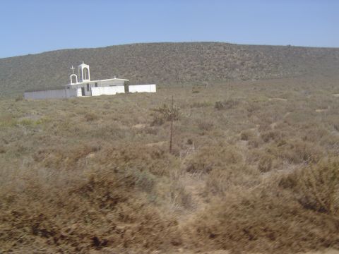 1985 Ford Ranger - A solitary church stands against a backdrop of arid hills and sparse vegetation.
