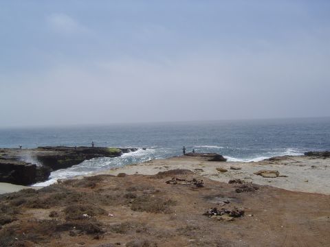 1985 Ford Ranger - A hazy day at the coast with people fishing on the rocks.
