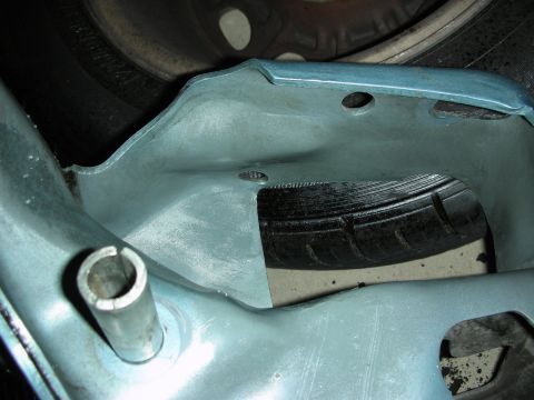 1990 Ford Mustang - Unidentified light blue car part is shown in close proximity to a tire.