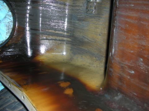 1990 Ford Mustang - The interior of an engine bay shows significant oil and grime accumulation, suggesting a need for cleaning or repair.