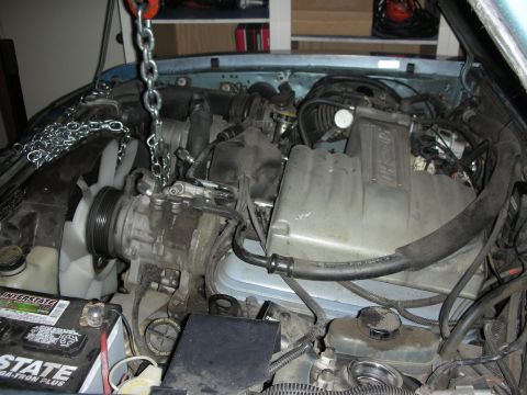 1990 Ford Mustang - Engine bay work in progress, with a chain hoist attached to the engine.
