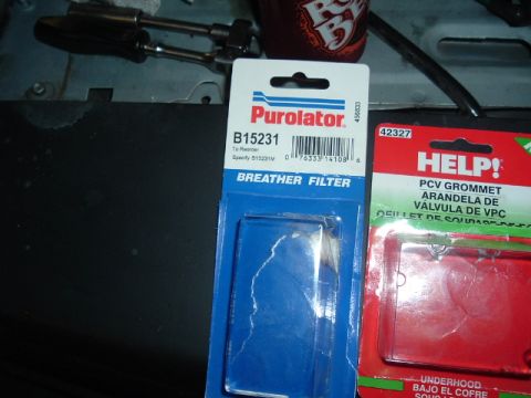 1989 Ford Crown Victoria LTD - Two automotive parts, a breather filter and a PCV grommet, are displayed in their packaging.