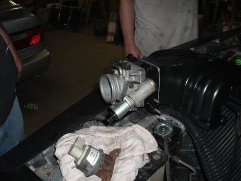 1989 Ford Crown Victoria LTD - A close-up view of a throttle body and sensor assembly, with a part number visible on the sensor.
