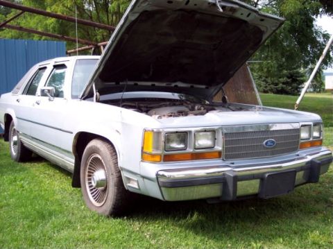1990 Ford Crown Victoria LTD - Front view of a 1990 Ford Crown Victoria LTD with its hood open.