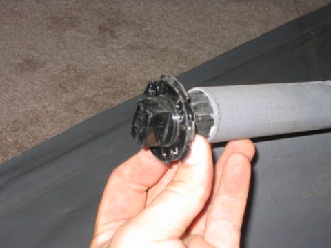 1995 Ford Bronco - This is what is underneath. If all you need to do is re-tension it so it will roll itself up all you have to do is take both ends off. If y…