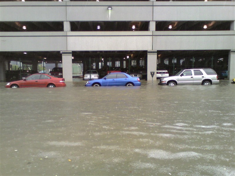 Blue Subaru sedan and other cars in flooded parking garage